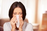 Sick young woman with fever, use tissues