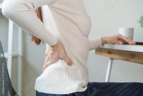 office syndrome  woman with back pain symptoms during work in the office.