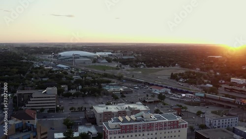 Aerial shot over the city of Regina at sunset, and mosaic stadium regina in the background.  photo