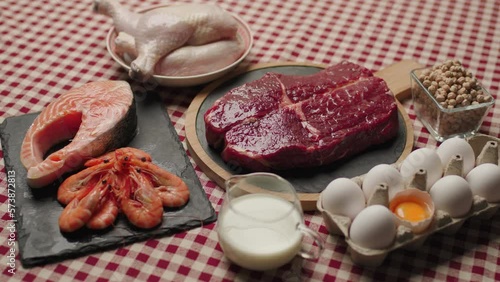Protein Food On The Table with 'Protein' sign. Beef, Eggs, Chicken And Milk. Products with high protein content. 