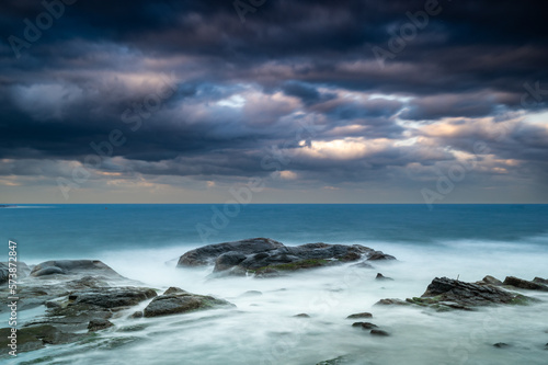 Looking at the vast sea and blowing the sea breeze, it is even more refreshing. Waves lapping at the rocks at dusk. Badouzi Coastal Park, Keelung City, Taiwan © twabian