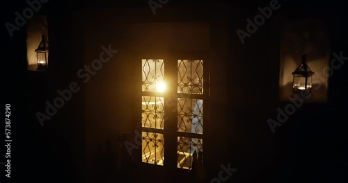 Light flaring through Mashrabiya Window in a Moroccan traditional House lit by candles photo