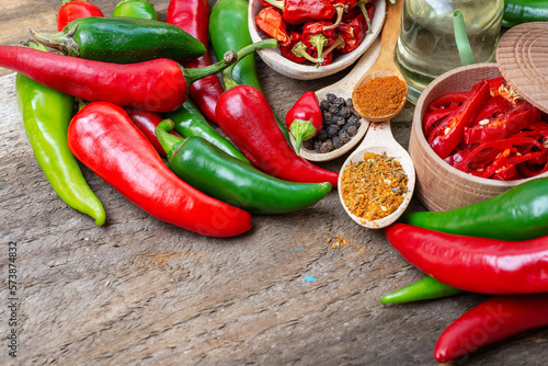 Photos different seasonings for cooking, varieties of hot chilli pepper, ground pepper and spices, oil