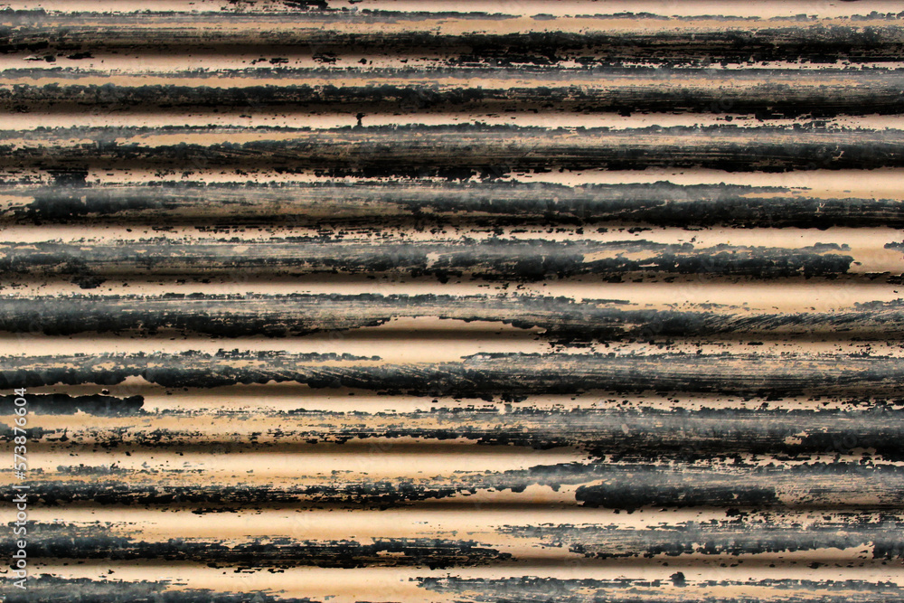 Corrugated metal sheet with flaking paint
