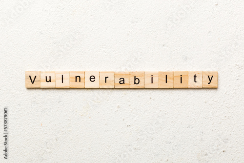 vulnerability word written on wood block. vulnerability text on table, concept