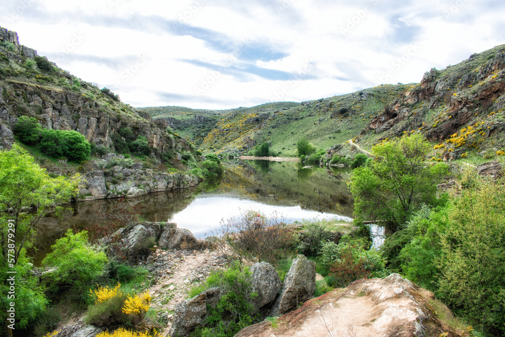 wide riverbed of a river passed between mountains on a sunny day wide riverbed of a river passed between mountains on a sunny day
