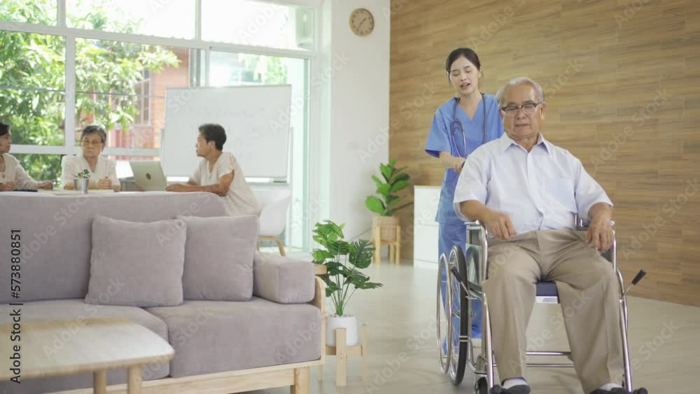 An Asian nurse talking to a group of old elderly patient or pensioner people smiling, relaxing, having fun together in nursing home. Senior lifestyle activity recreation. Retirement. Health care An Asian nurse talking to a group of old elderly patient or pensioner people smiling, relaxing, having fun together in nursing home. Senior lifestyle activity recreation. Retirement. Health care