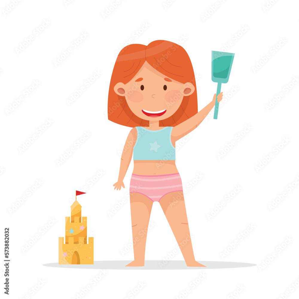 Cute girl with red hair building sand castle Cute girl with red hair building sand castle