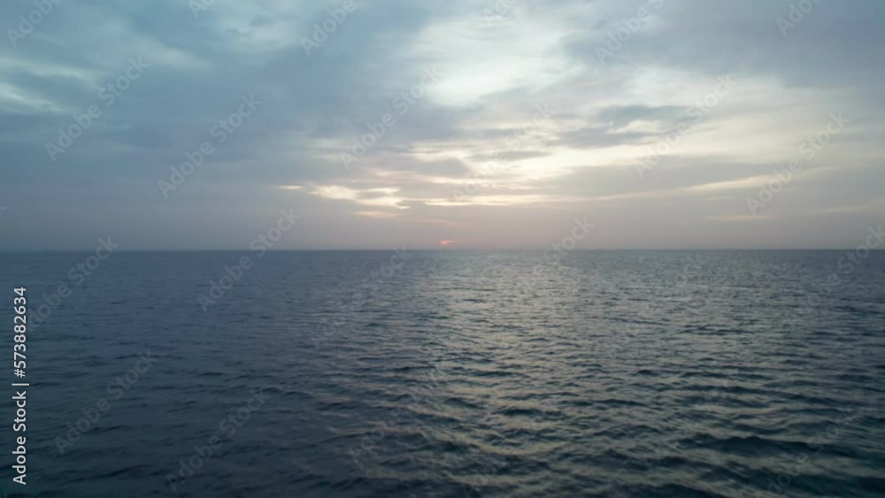 View of the clouds over the sea at sunrise. Blues mix with oranges, golden hour. View of the clouds over the sea at sunrise. Blues mix with oranges, golden hour.