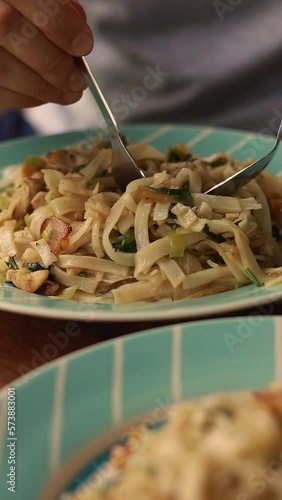 Vertical video of eating a plate full of traditional Cha Me Kataing or Cambodian pan fried rice noodles photo