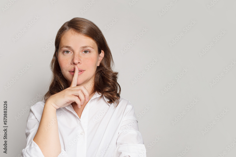 Portrait of woman with finger near lips, secret, silence and gossip concept Portrait of woman with finger near lips, secret, silence and gossip concept