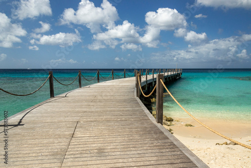 Wooden pier walkway on a beach with turquoise sea at  Speightstown Barbados