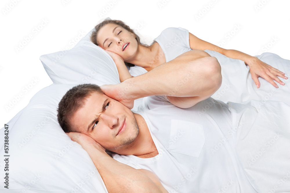 Fed up man blocking his ears from noise of his wife snoring Fed up man blocking his ears from noise of his wife snoring