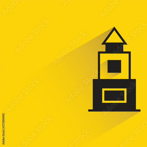 building with shadow on yellow background