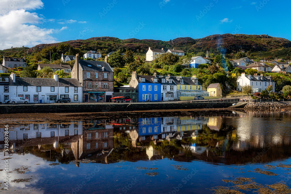 Reflections of houses in the harbour at Tarbert, Scotland, United Kingdom