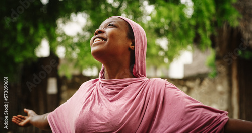 Photos Portrait of Authentic African Woman Enjoying the Blessing of Falling Rain