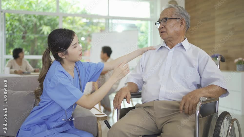 An Asian nurse talking to a group of old elderly patient or pensioner people smiling, relaxing, having fun together in nursing home. Senior lifestyle activity recreation. Retirement. Health care An Asian nurse talking to a group of old elderly patient or pensioner people smiling, relaxing, having fun together in nursing home. Senior lifestyle activity recreation. Retirement. Health care