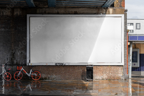 Blank billboard sign mockup in the urban environment, on the facade, empty space to display your advertising or branding campaign photo