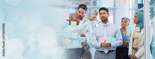 Meeting, collaboration and sticky notes with a business man training a team while planning strategy on glass in an office. Teamwork, diversity and workshop with a man and woman employee group at work photo