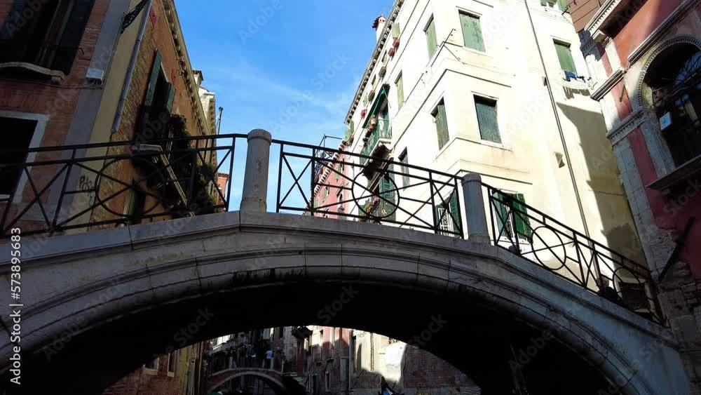 Gondola Tour Passing Under Riato Bridge In Venice, Italy. Low Angle Gondola Tour Passing Under Riato Bridge In Venice, Italy. Low Angle