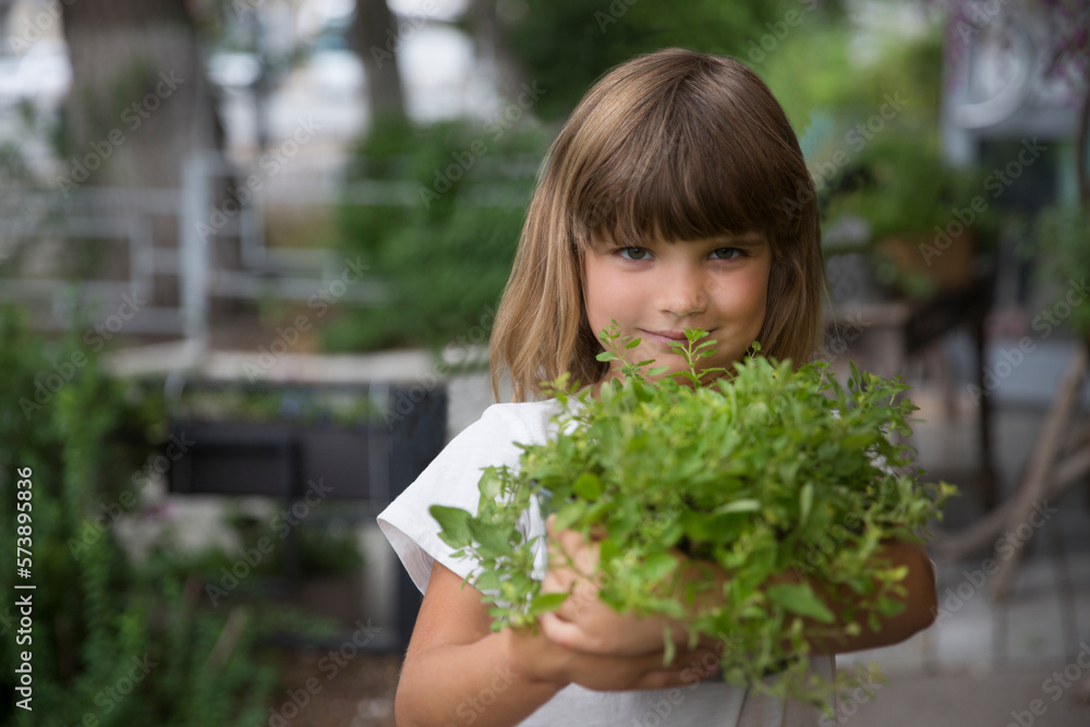 child girl holding pot with mixed green fresh aromatic herbs in garden near the house. enjoy the little things. favorite family hobby. Eco-friendly. child girl holding pot with mixed green fresh aromatic herbs in garden near the house. enjoy the little things. favorite family hobby. Eco-friendly.