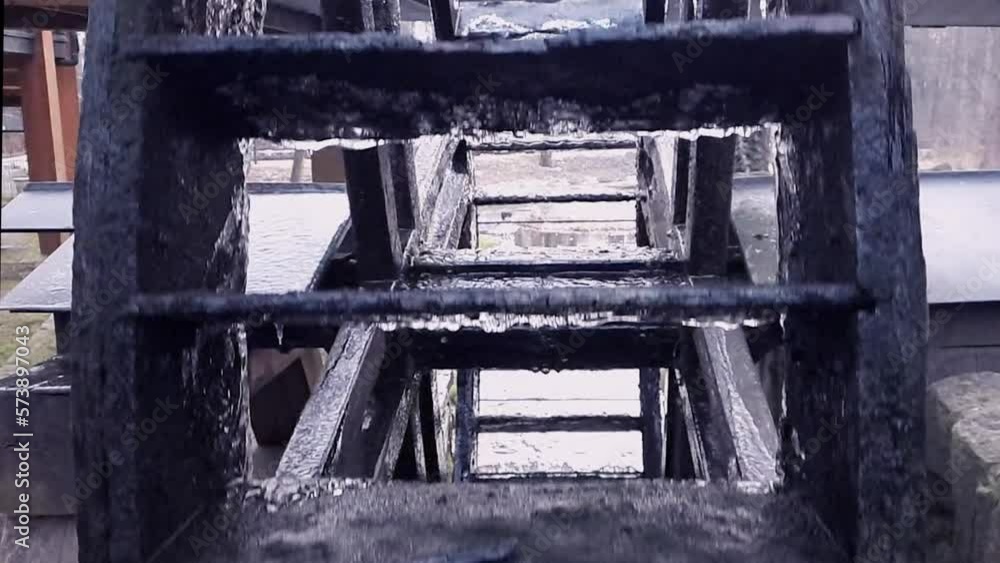 Slow rotation of mill wooden wheel in river. Slow motion. Water wheel spin close-up. Concept of overcoming difficulties, difficulty on way to goal and success, hard work, career. Slow rotation of mill wooden wheel in river. Slow motion. Water wheel spin close-up. Concept of overcoming difficulties, difficulty on way to goal and success, hard work, career.