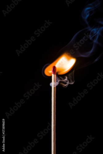 Lighting matches at the moment when it explodes. Burning match on black background. 