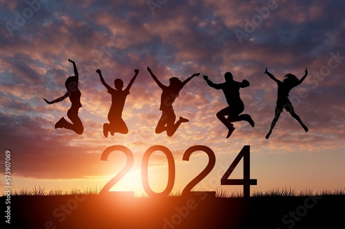 Happy people group jump with 2023 numbers.