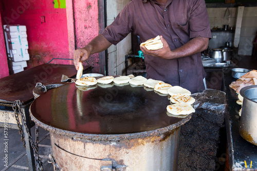 Man in restaurant doing parotta bread for lunch and dinner photo