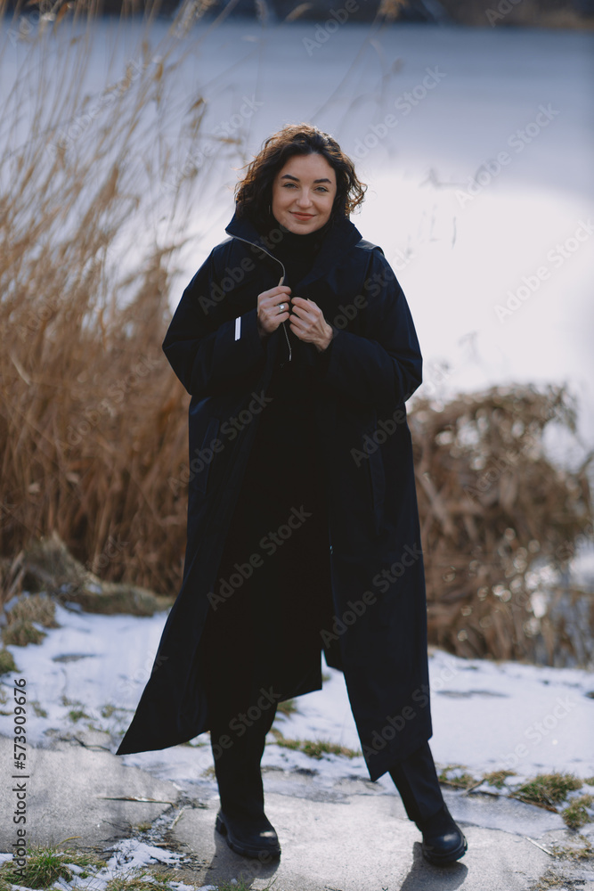 A beautiful girl walks on a sunny winter day A beautiful girl walks on a sunny winter day