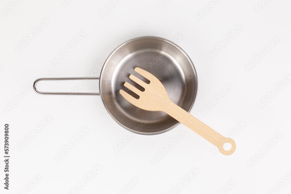 a metal pan with a wooden spatula for cooking a metal pan with a wooden spatula for cooking