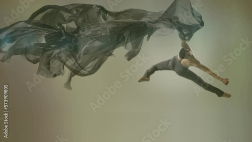 Art dance moves with long fabrics . Few shots of the powerful psychological contemporary ballet dancing movements with large textile materials . People dancing , flying , jumping . Growth of cloth