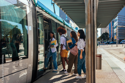 University students entering train.