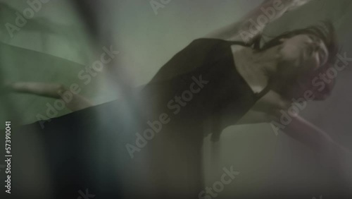 Art dance moves with long fabrics . Few shots of the powerful psychological contemporary ballet dancing movements with large textile materials . People dancing , flying , jumping . Growth of cloth