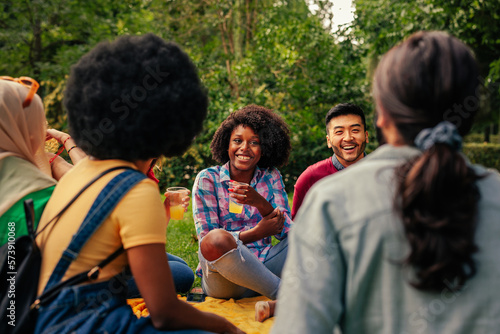 Group of friends hang out in park