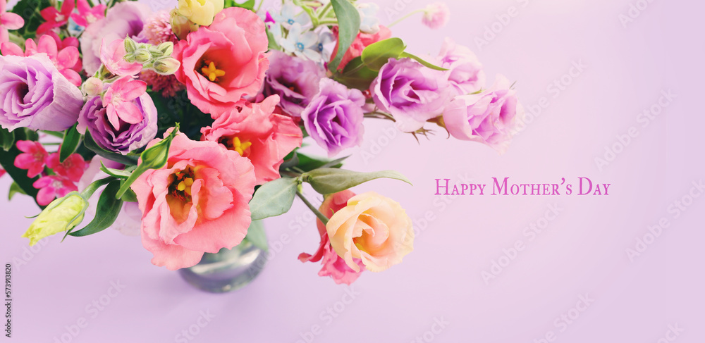 mother's day concept with pink and purple flowers over pastel background