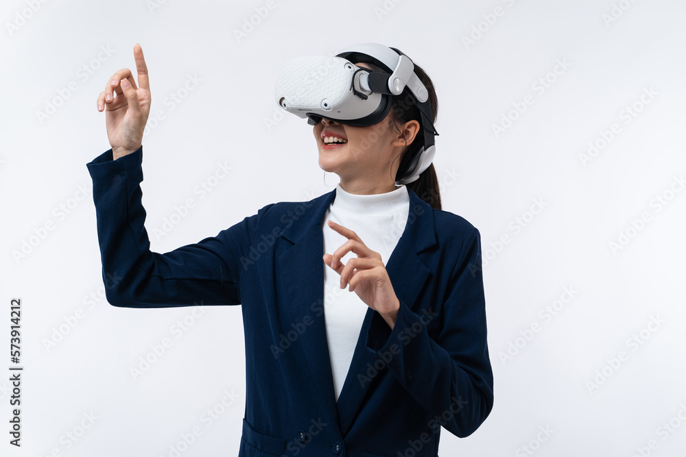 Happy young Asian businesswoman working in virtual reality environment in VR glasses touching virtual interface isolated on white background. Happy young Asian businesswoman working in virtual reality environment in VR glasses touching virtual interface isolated on white background.
