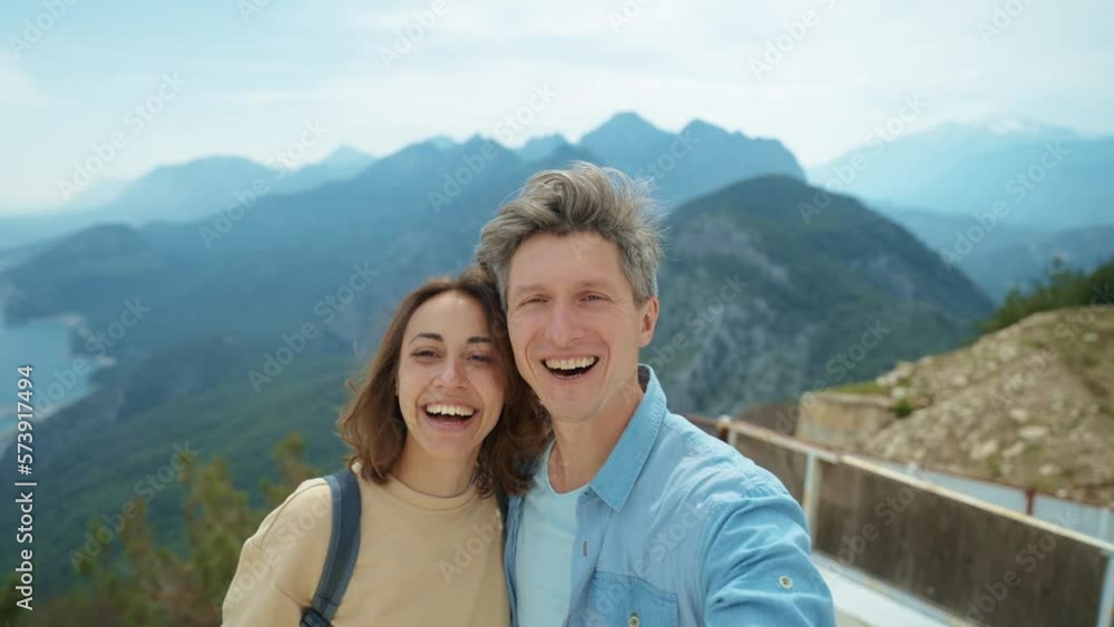 couple happy tourists standing in front of mountain top with cloudy sky at viewpoint of Tunektepe Teleferik, Antalya. man and woman enjoying travel together, taking selfie, hugging and kissing couple happy tourists standing in front of mountain top with cloudy sky at viewpoint of Tunektepe Teleferik, Antalya. man and woman enjoying travel together, taking selfie, hugging and kissing