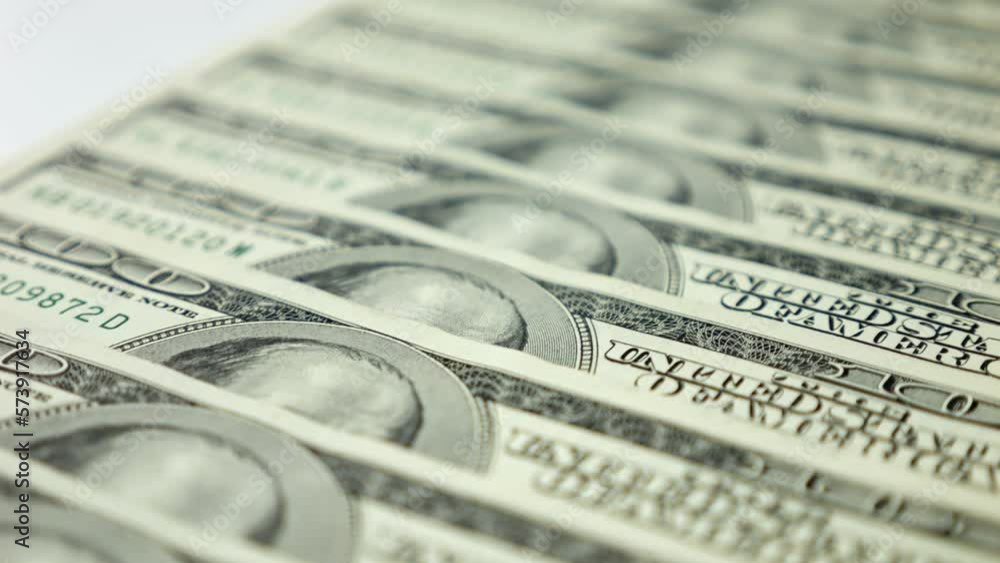 Pile of dollar banknotes lying on white table for verifying authenticity. Large stack of money cash placed on surface to check for fakeness Pile of dollar banknotes lying on white table for verifying authenticity. Large stack of money cash placed on surface to check for fakeness