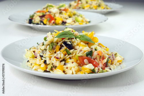 Plate with a Mediterranean salad with orzo pasta photo