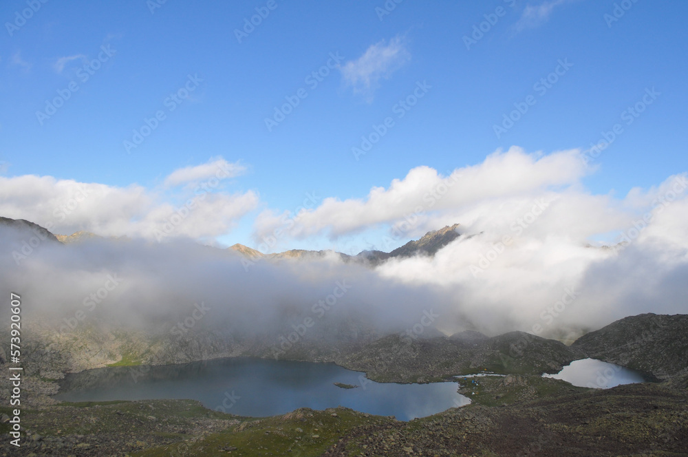 Mountain lake, a lake in the clouds between the mountains under the blue sky Mountain lake, a lake in the clouds between the mountains under the blue sky