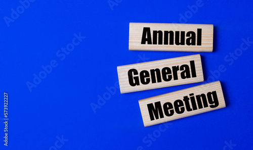 Three wooden blocks with the text AGM Annual General Meeting photo