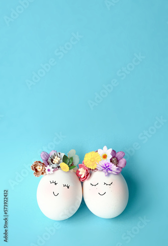 Funny Easter Eggs, hand drawn faces. Easter holiday concept with cute handmade eggs in floral wreath crowns.