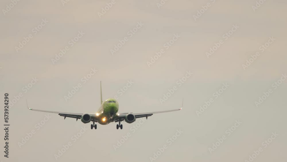 Unrecognizable jet passenger plane approaching landing, front view. Airliner fly, front view. Footage of an airplane in the sky Unrecognizable jet passenger plane approaching landing, front view. Airliner fly, front view. Footage of an airplane in the sky
