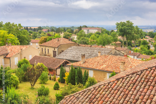 Summer city landscape - view of the roofs of houses in a provincial French town, in the historical province Gascony, the region of Occitanie of southwestern France photo
