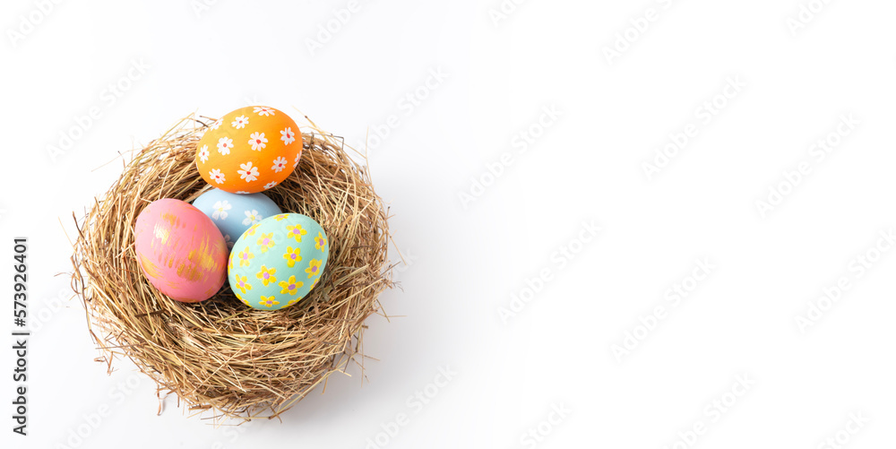Fototapeta premium Colorful easter eggs in nest on white copy space background.