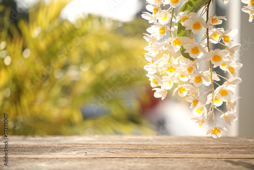 white wild orchid plant flower close up with wooden table surface photo