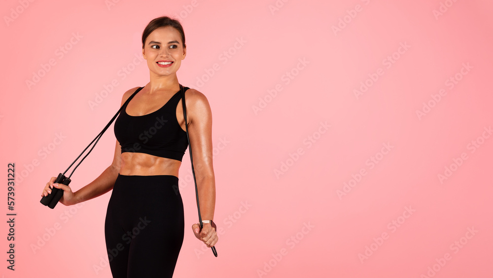 Fitness Offer. Beautiful Sporty Female Posing With Skipping Rope Over Pink Background Fitness Offer. Beautiful Sporty Female Posing With Skipping Rope Over Pink Background