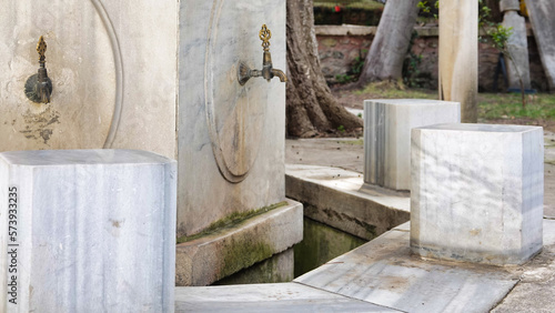 A historical public ablution place in the courtyard of the Ottoman Mosque. Close Up View of Ablution Fountains and stools. Ramadan prayer background