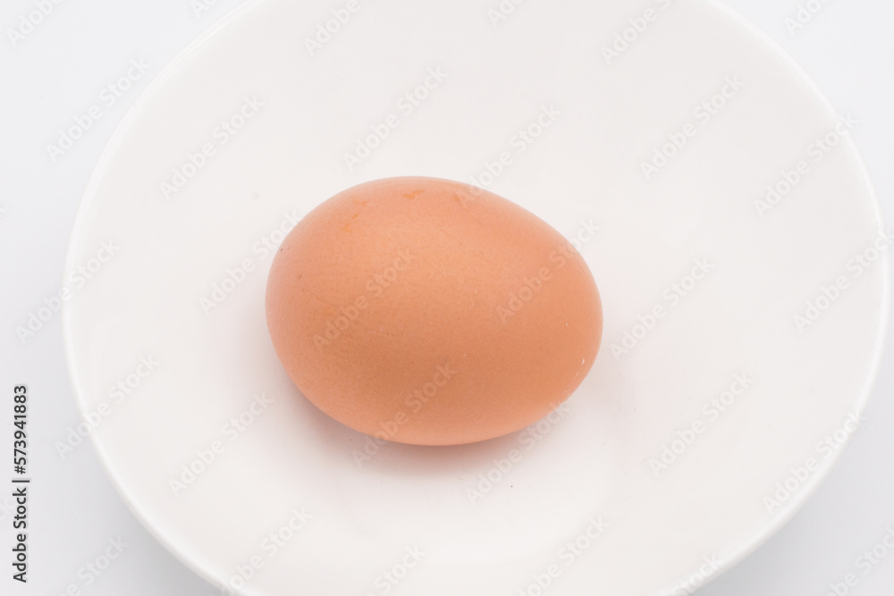One chicken egg in a white bowl One chicken egg in a white bowl